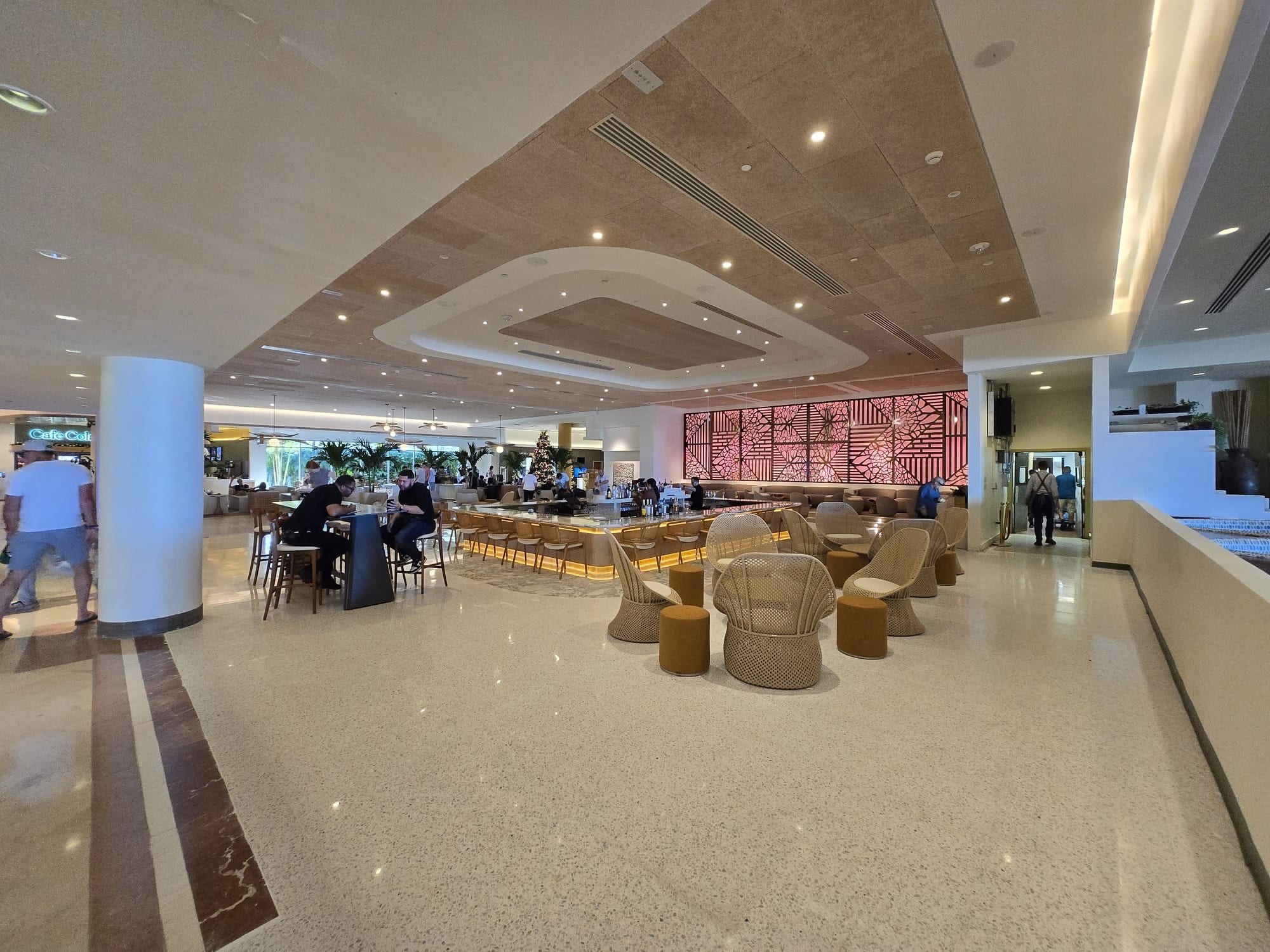 Wide view of the finished hotel lobby, bar, columns, and ceiling coves