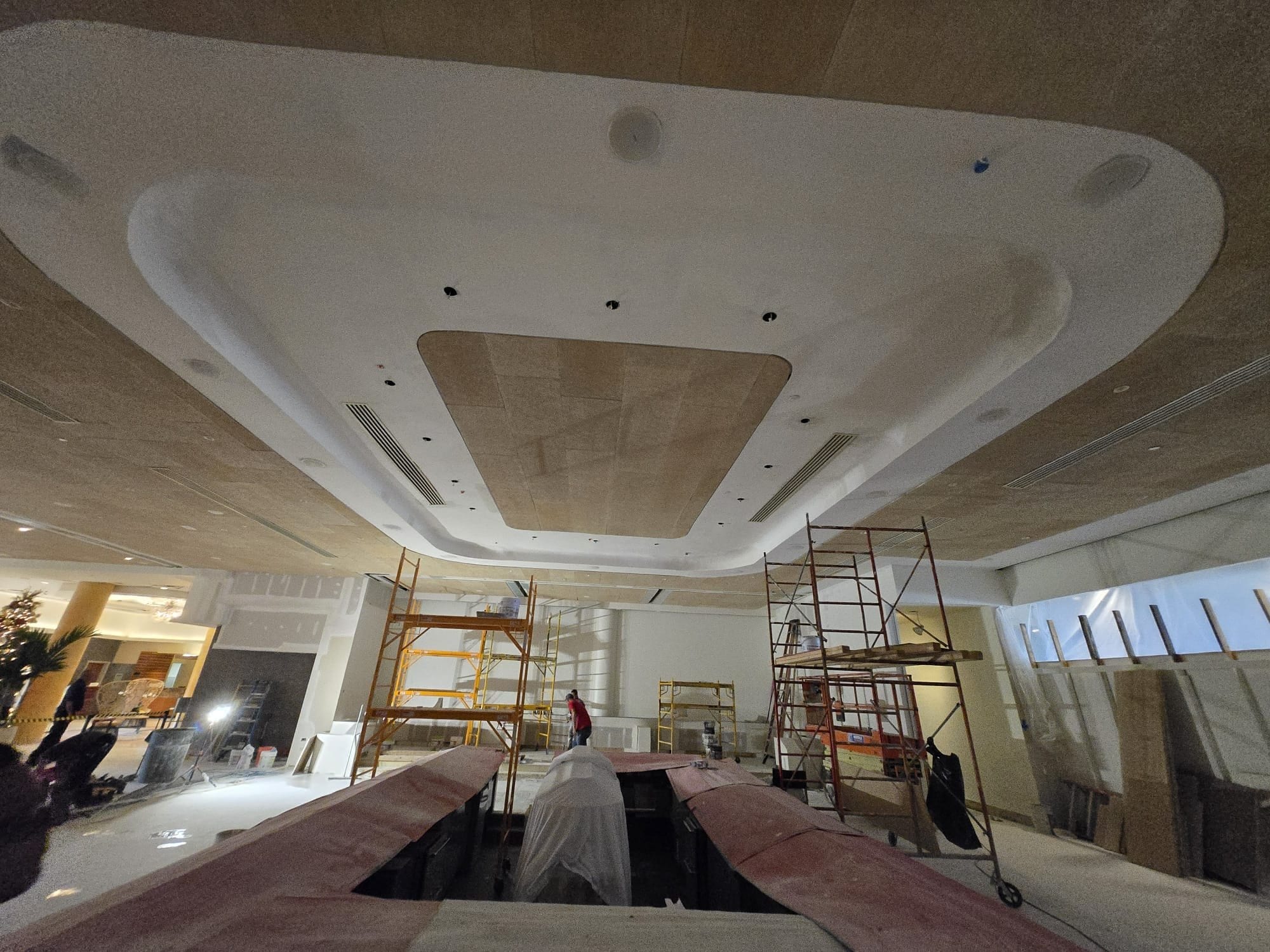 Hotel lobby during installation of a sculpted ceiling cove