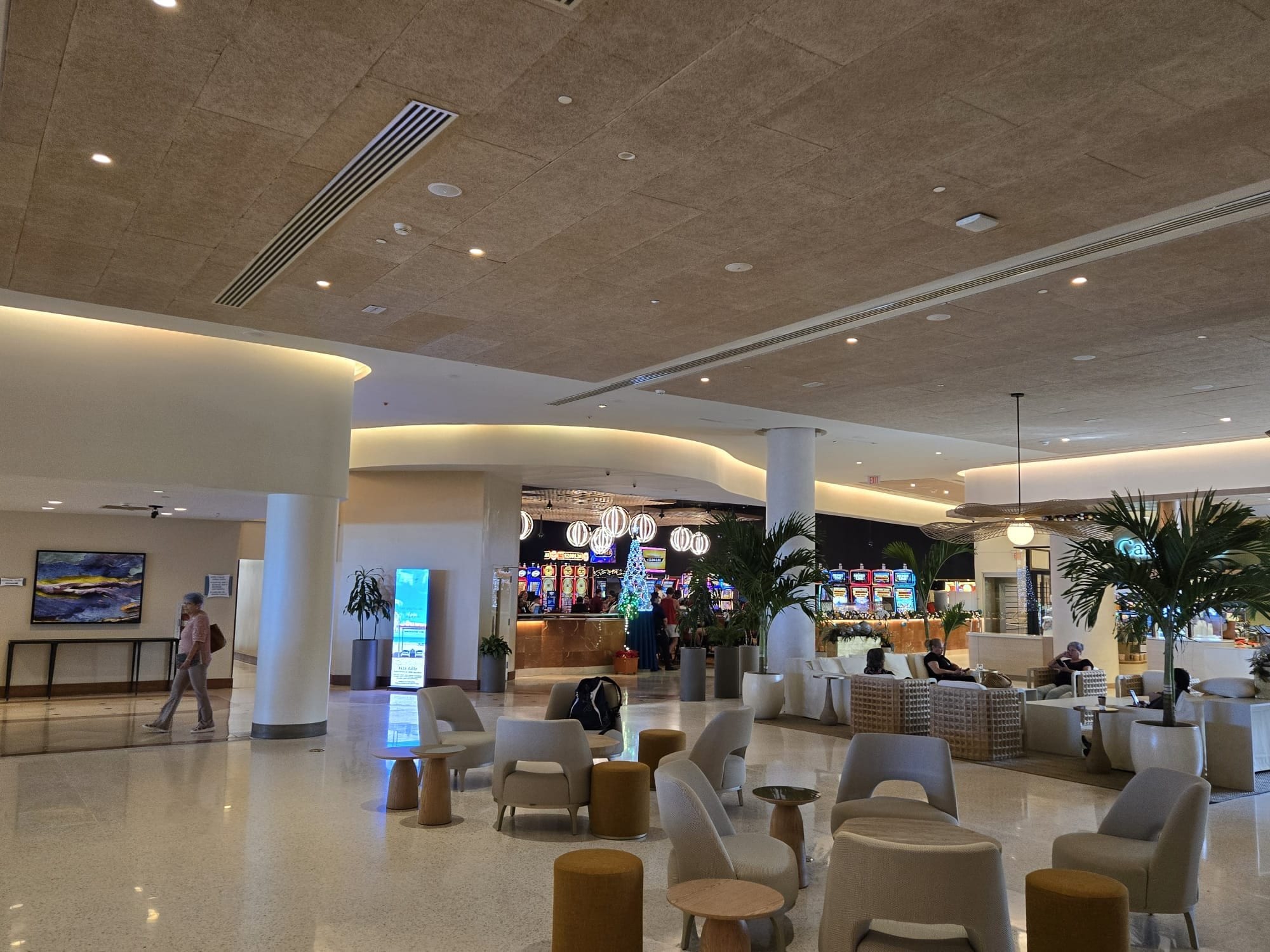 Finished lounge seating and bar beneath a broad ceiling plane