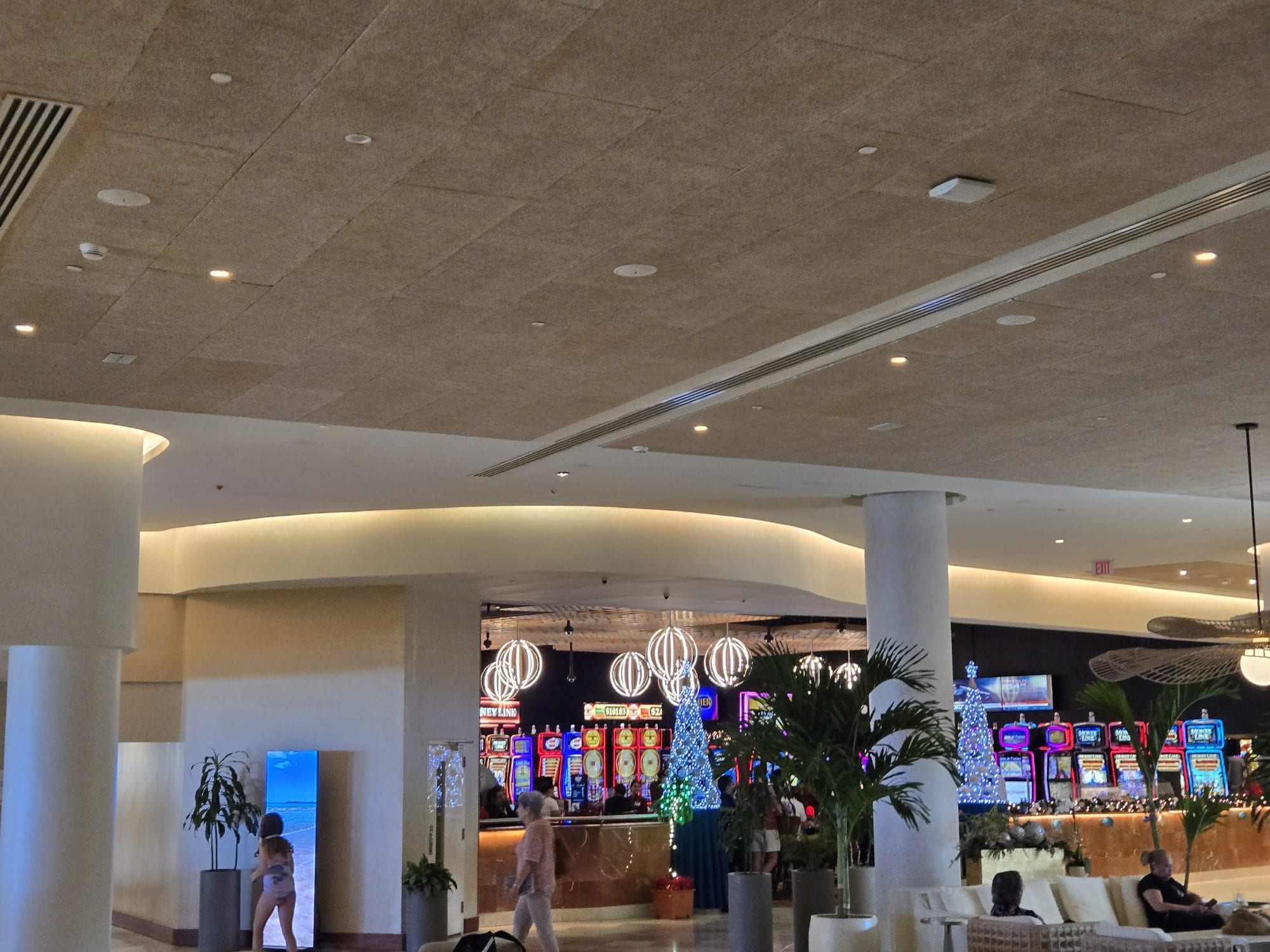 Finished hotel lounge with curved ceiling coves and white columns
