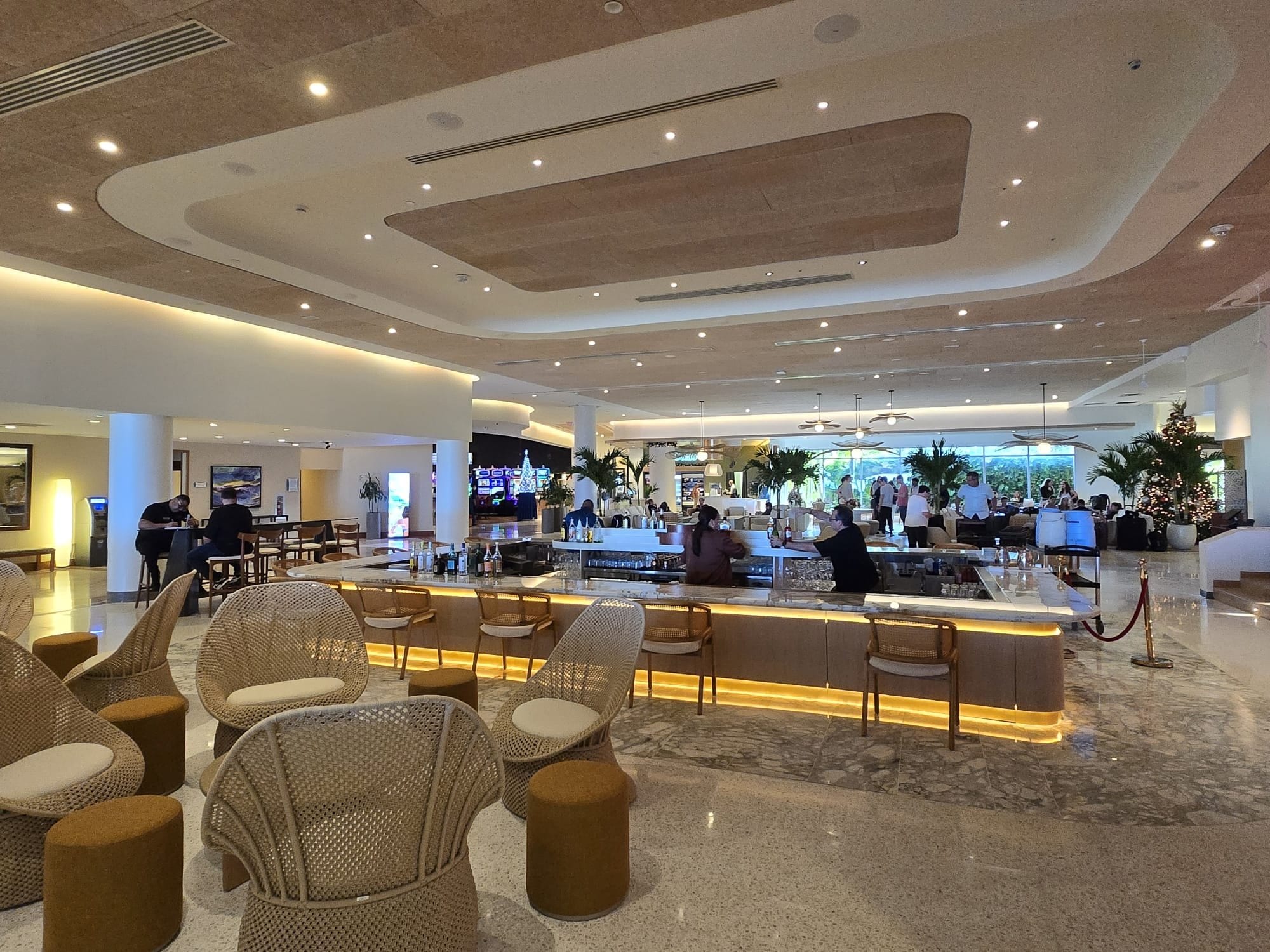 Finished hotel bar beneath layered curved ceiling coves