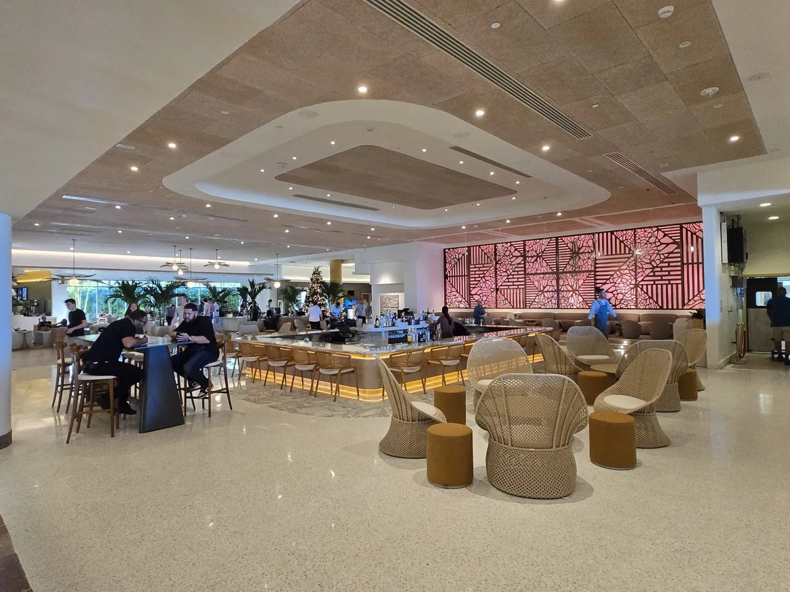 Finished hospitality interior with sculpted ceiling coves and a backlit screen wall