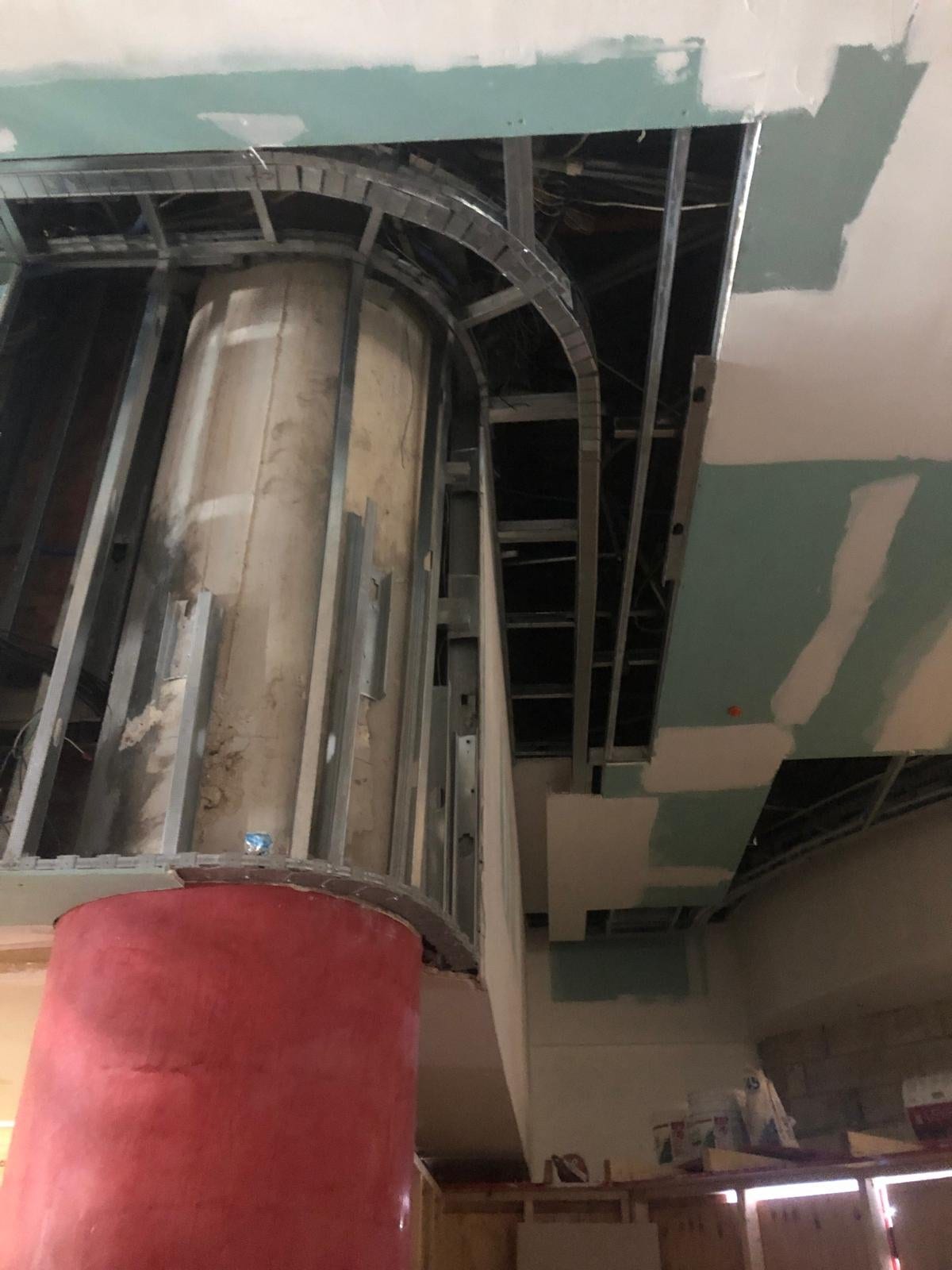 Circular column framing beneath a curved ceiling under construction